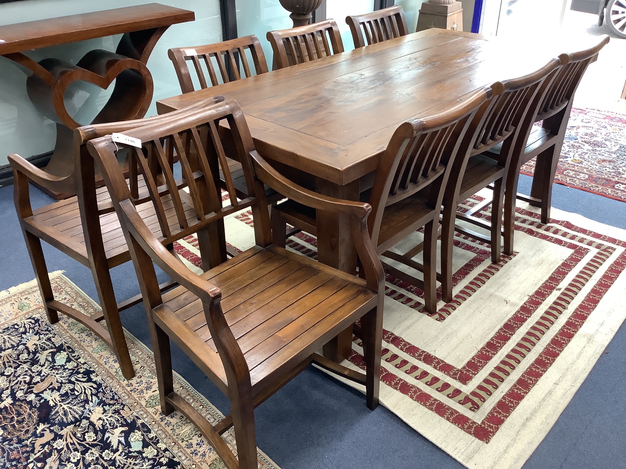 An 18th century style teak rectangular topped dining table and eight chairs